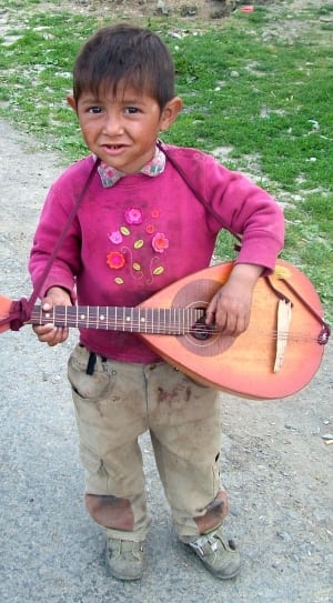 boy's pink floral collared sweater,brown cargo pants,gray shoes and brown string instrument thumbnail