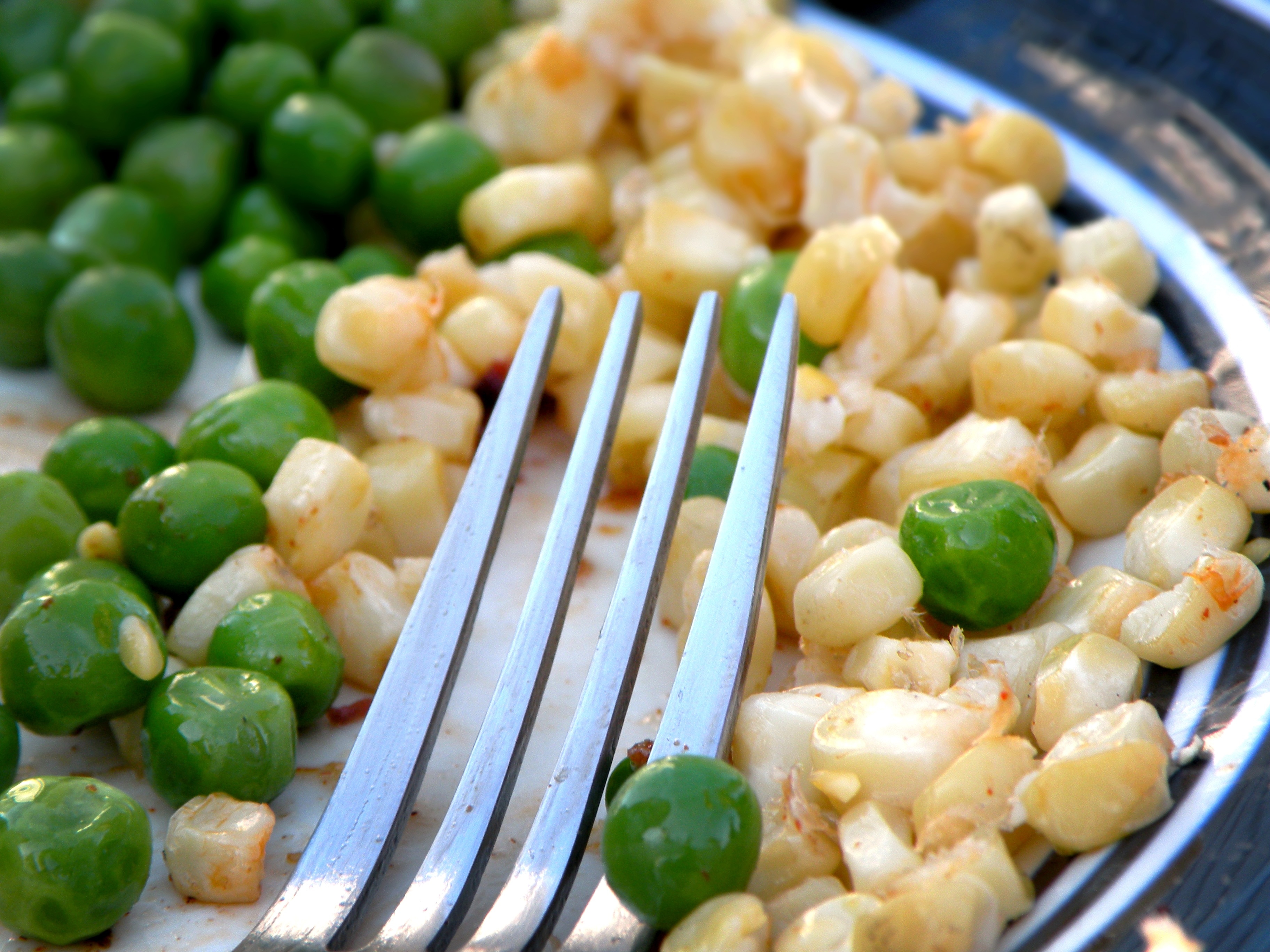 stainless steel fork, corn and peas
