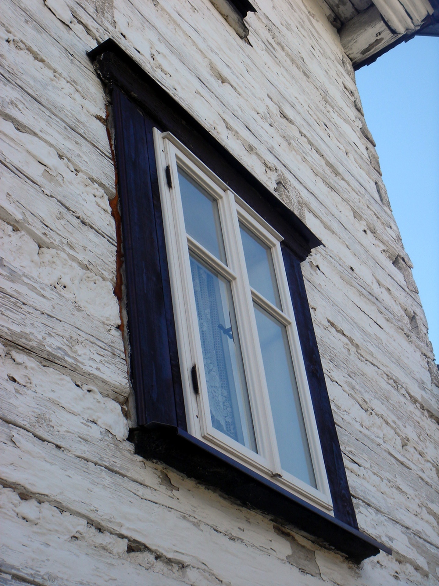 white and black wooden framed glass center window cover