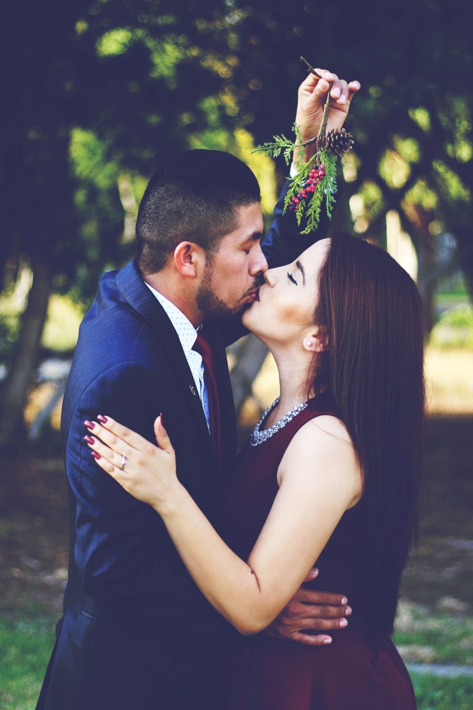 man holding mistletoe kissing woman preview