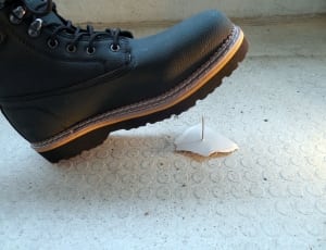 unpaired black leather work boot thumbnail