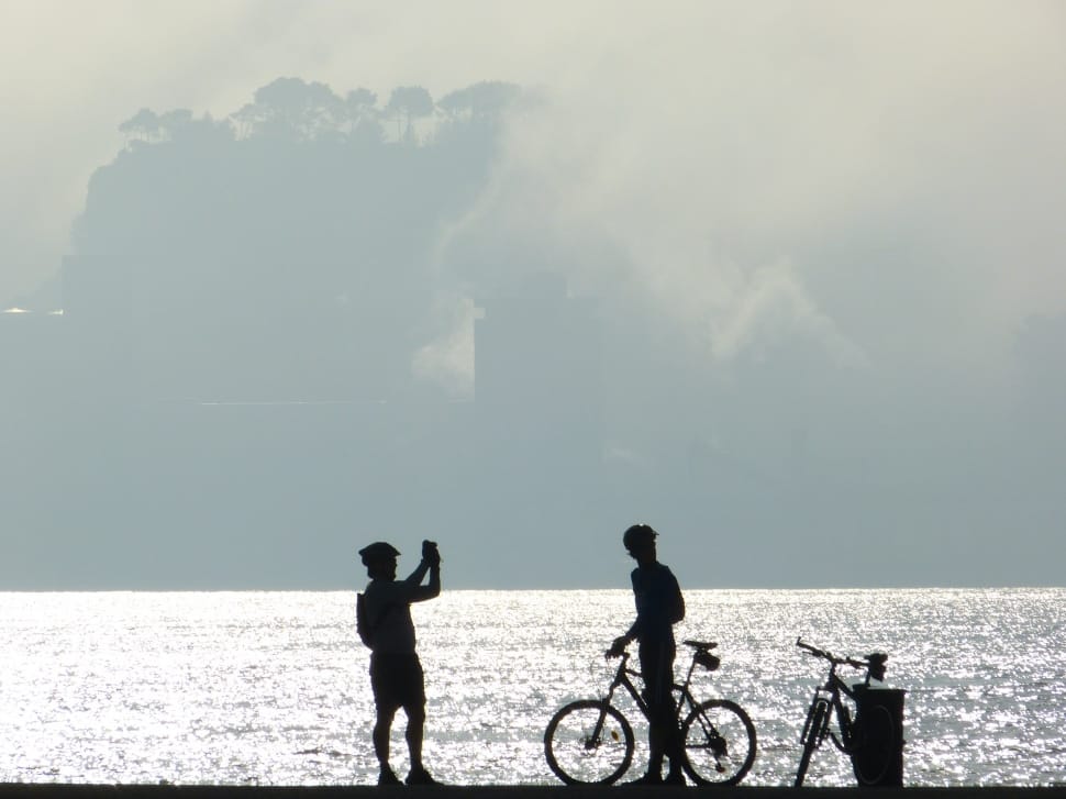 silhouette of men and bicycle preview