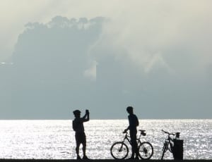 silhouette of men and bicycle thumbnail