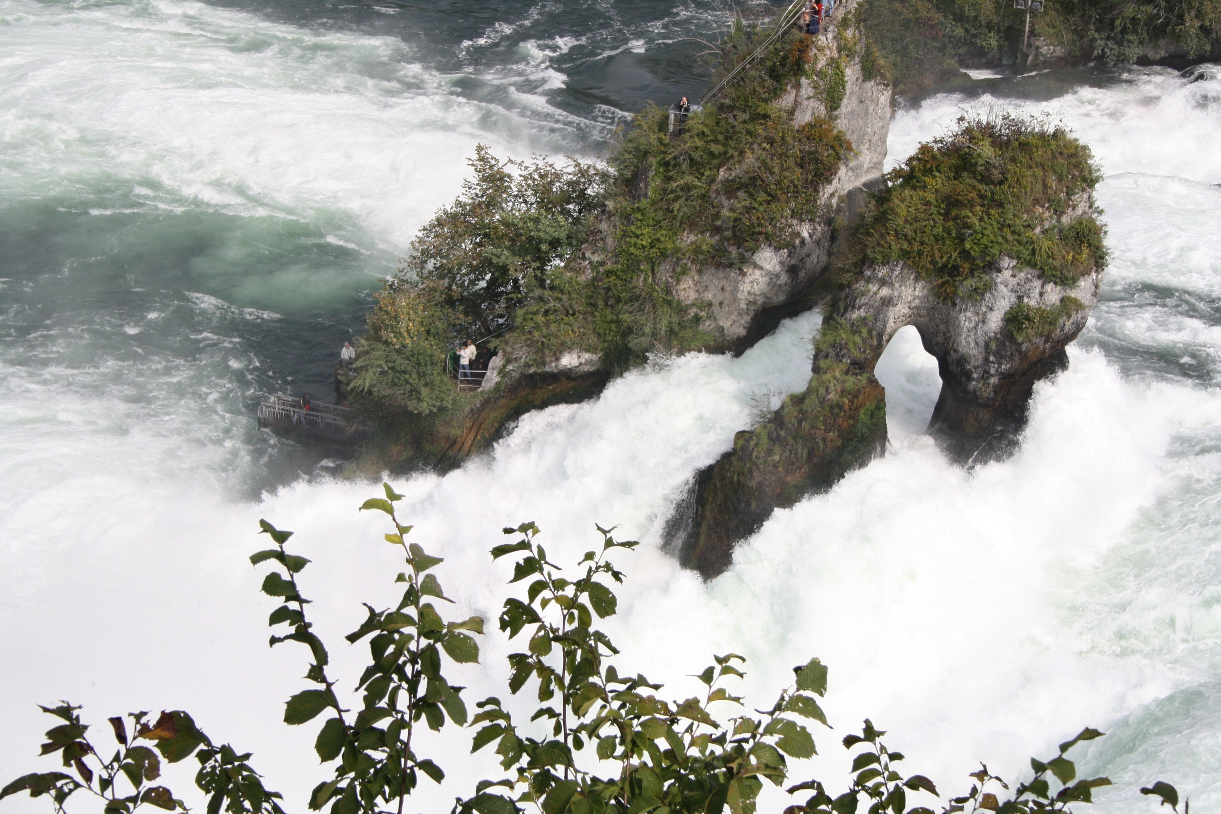 crashing body of water on gray rock formation