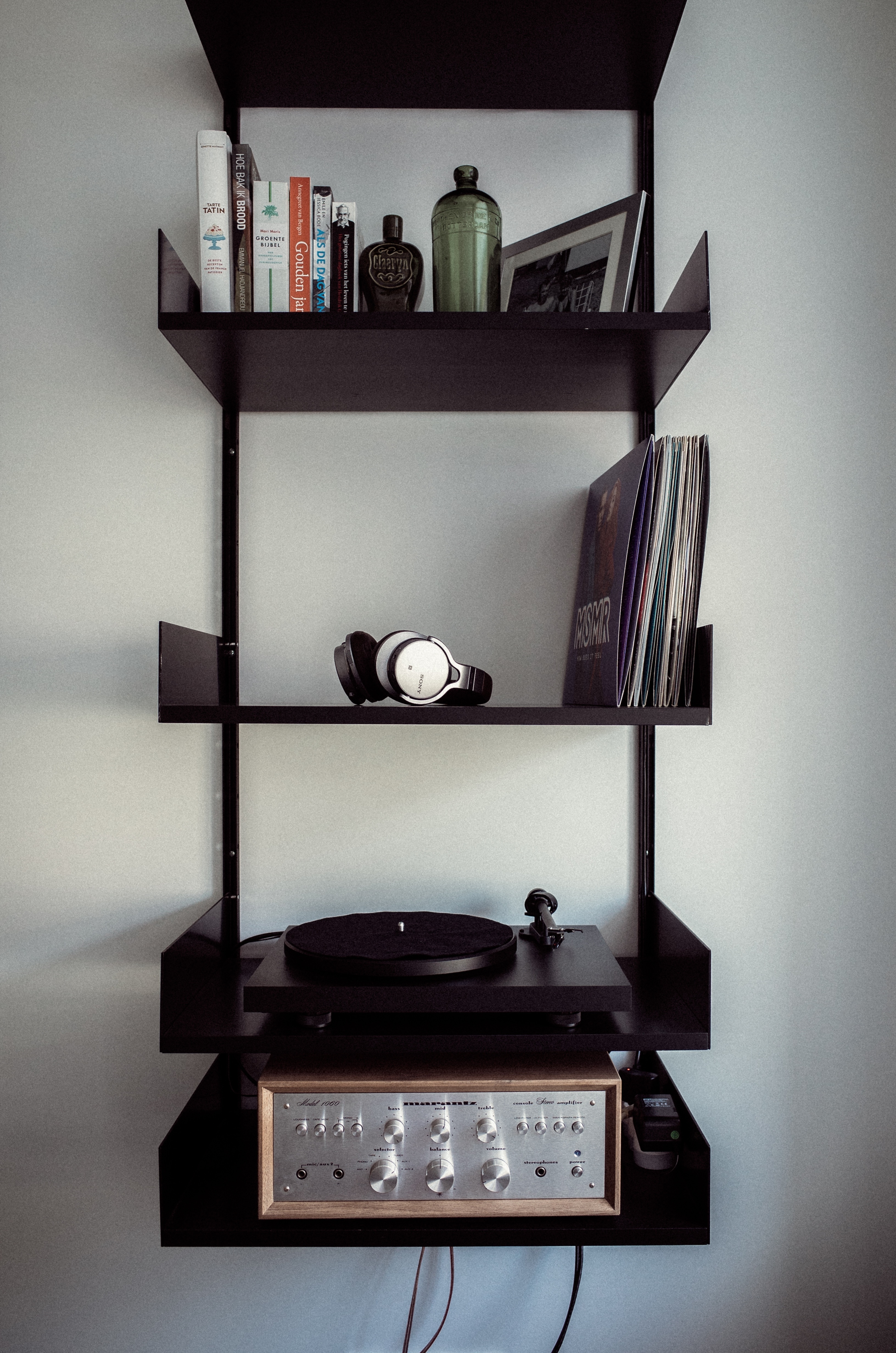 black vinyl record player and shelf