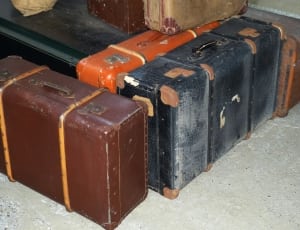 3 brown and black and orange suitcase thumbnail