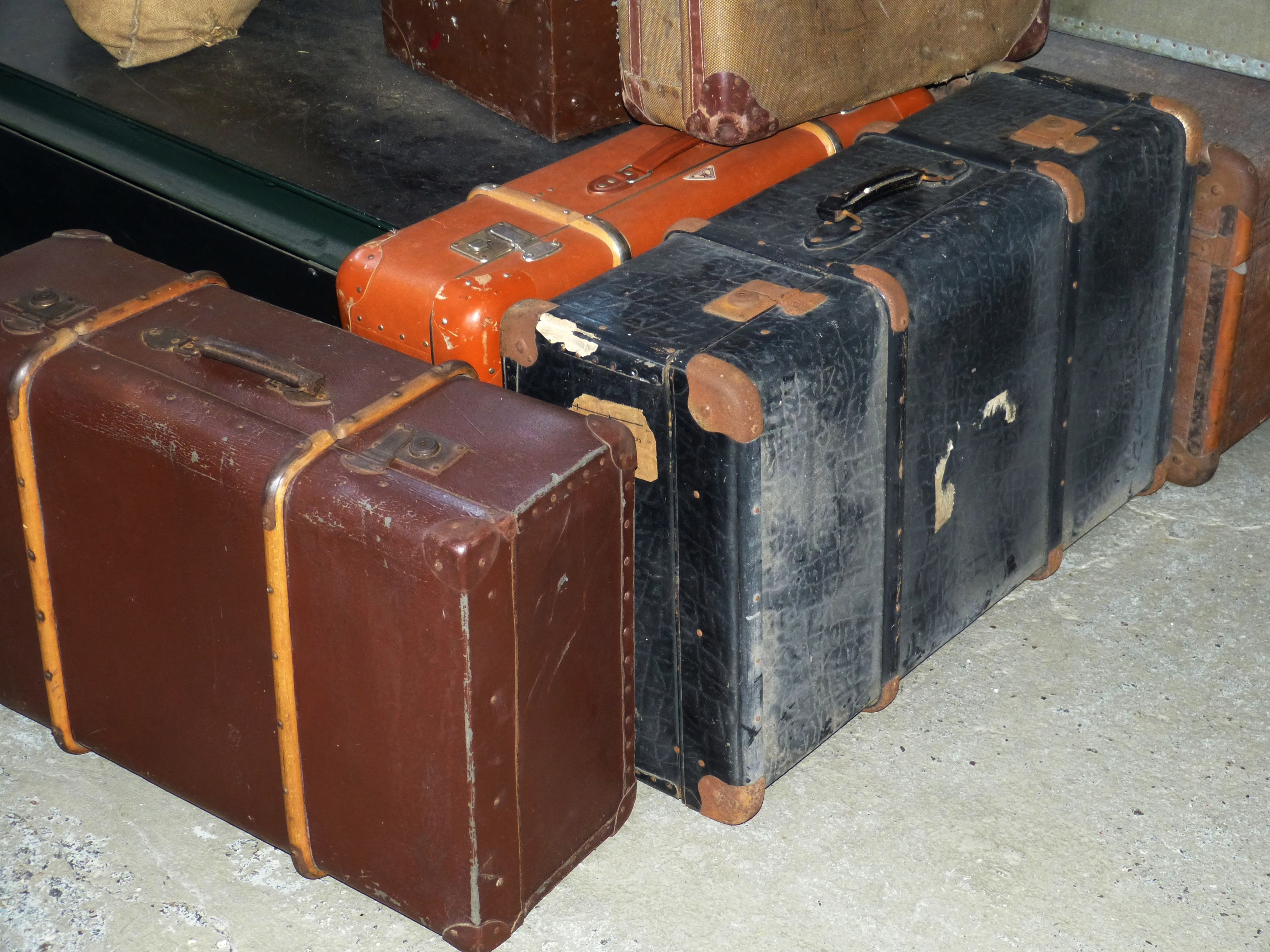 3 brown and black and orange suitcase