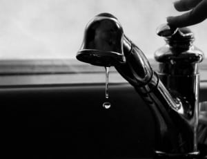 grayscale faucet with dripping water photography thumbnail