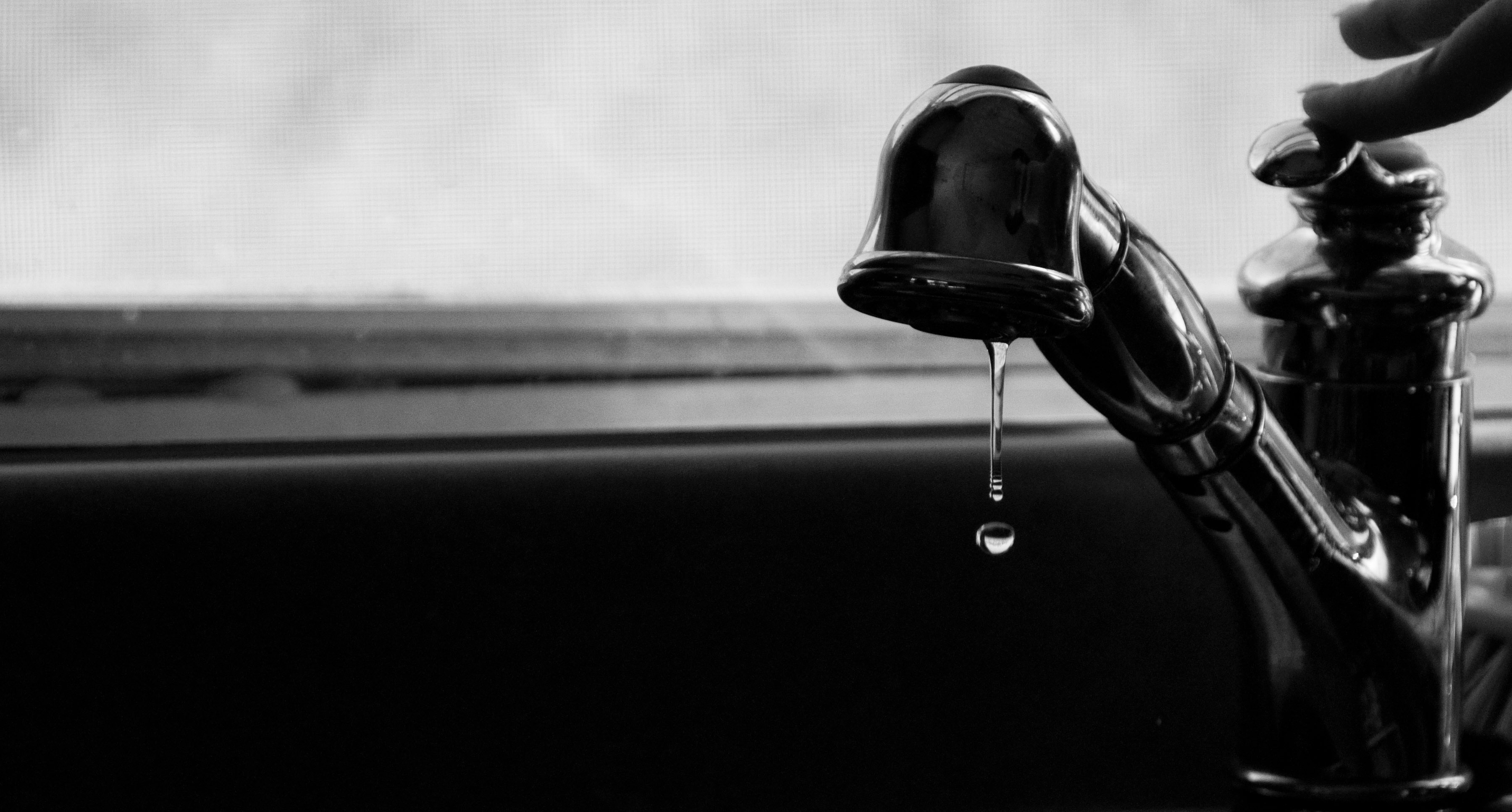grayscale faucet with dripping water photography