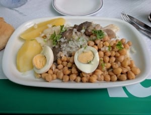brown beans, meat and sliced egg on white ceramic rectangular plate thumbnail