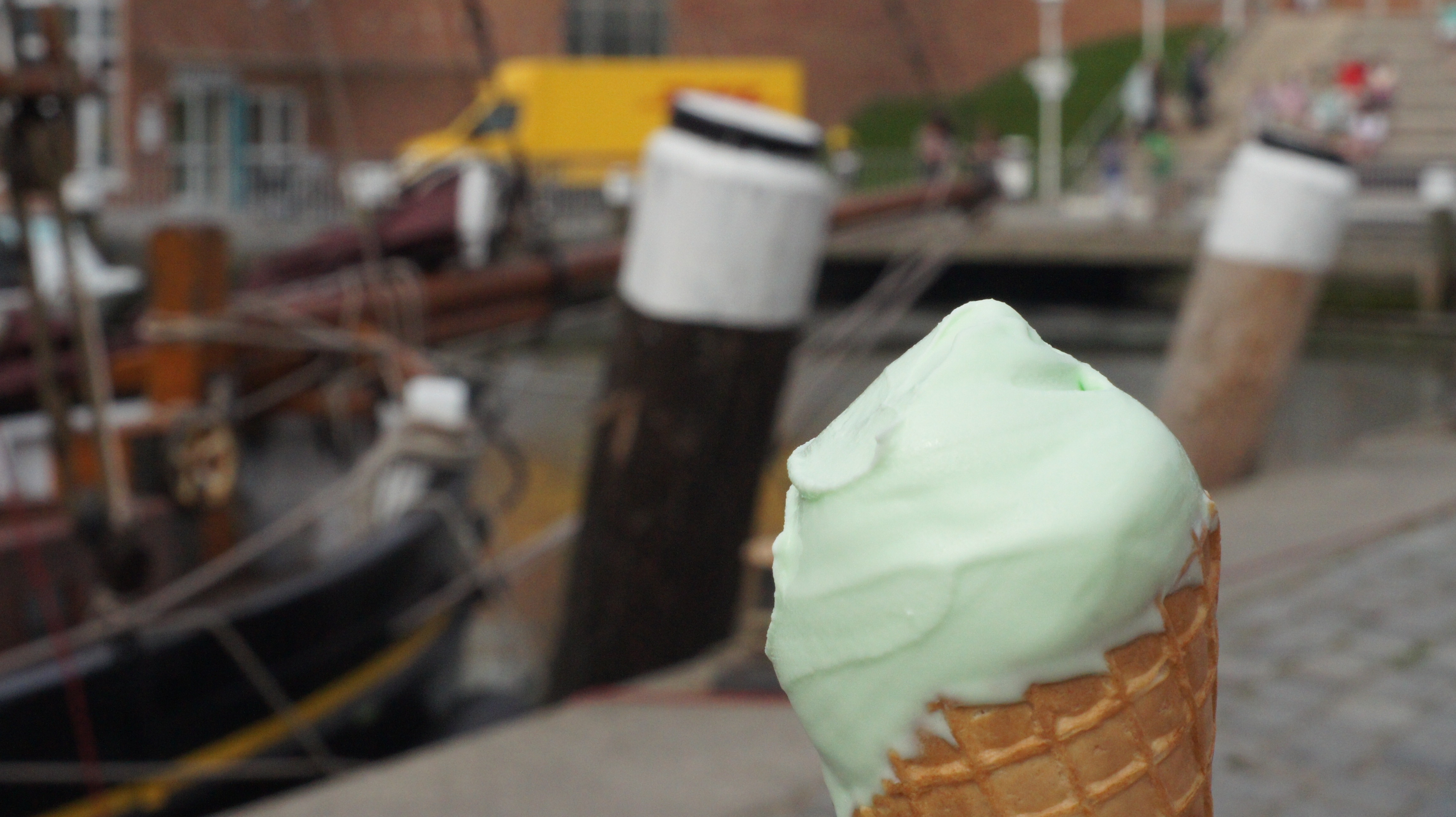 selective focus photograph of vanilla ice cream near black fishing boat