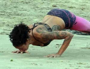woman doing push ups on the sand thumbnail