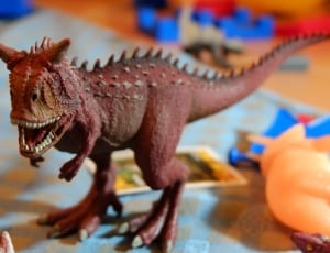 red tyranosaurus toy thumbnail