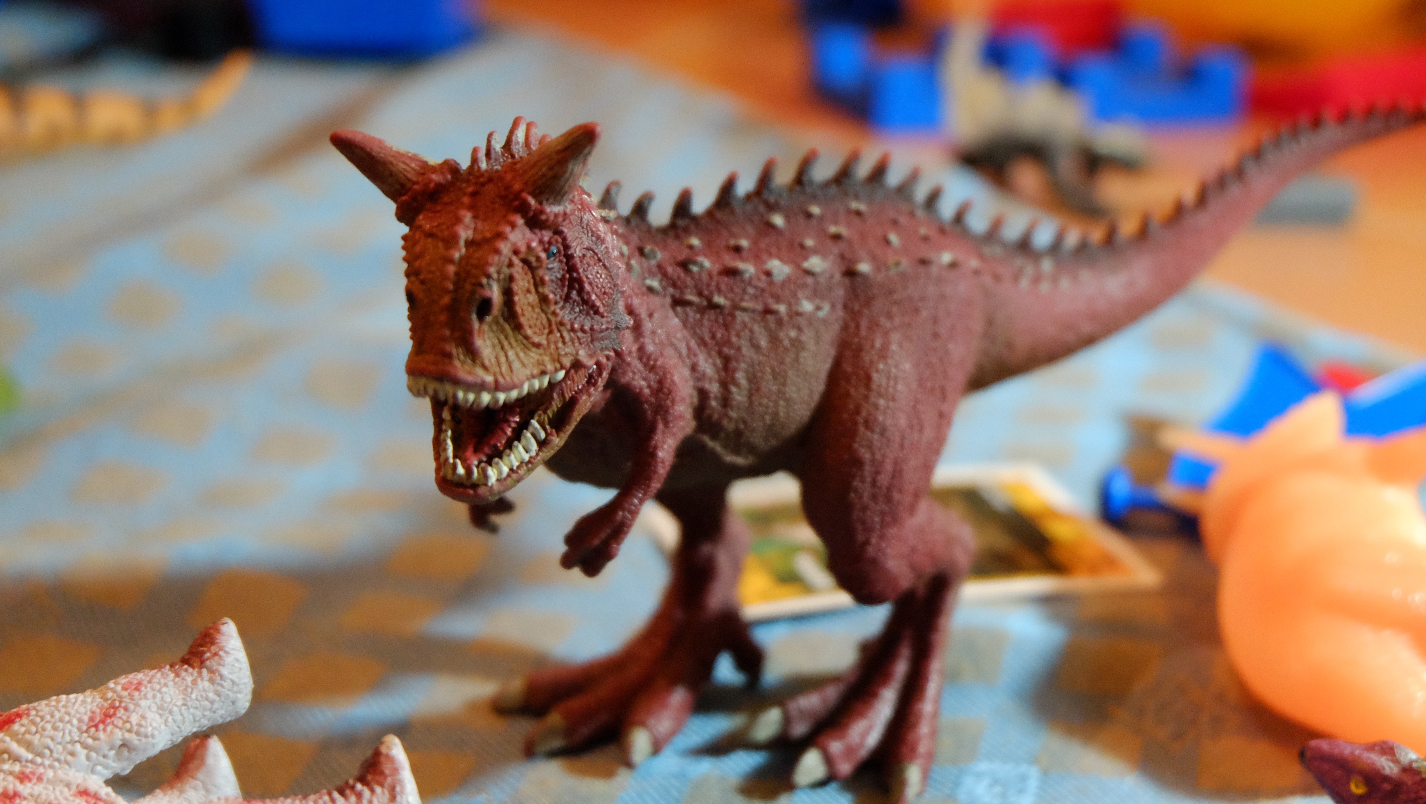 red tyranosaurus toy