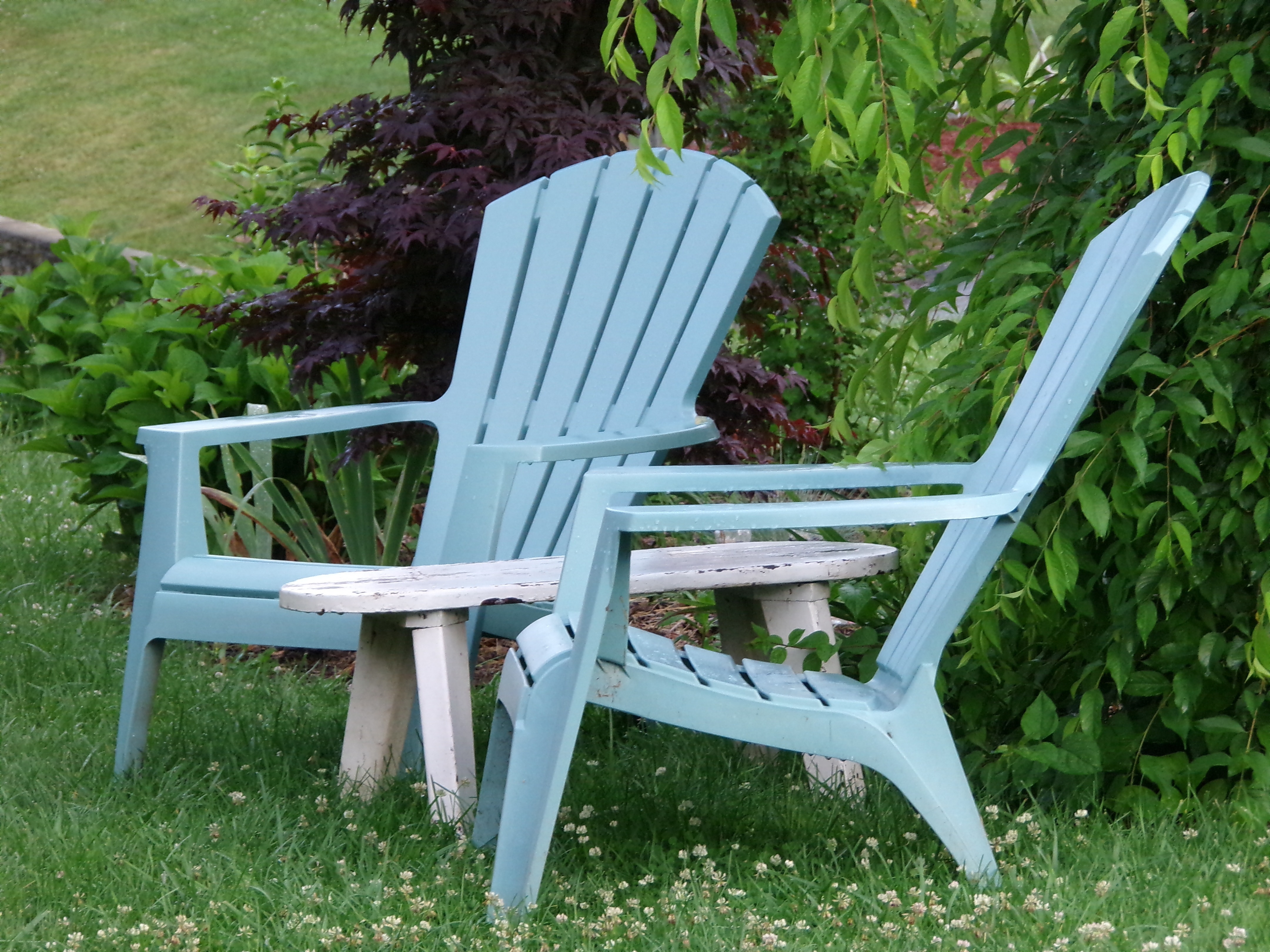 2 teal wooden adirondack chairs