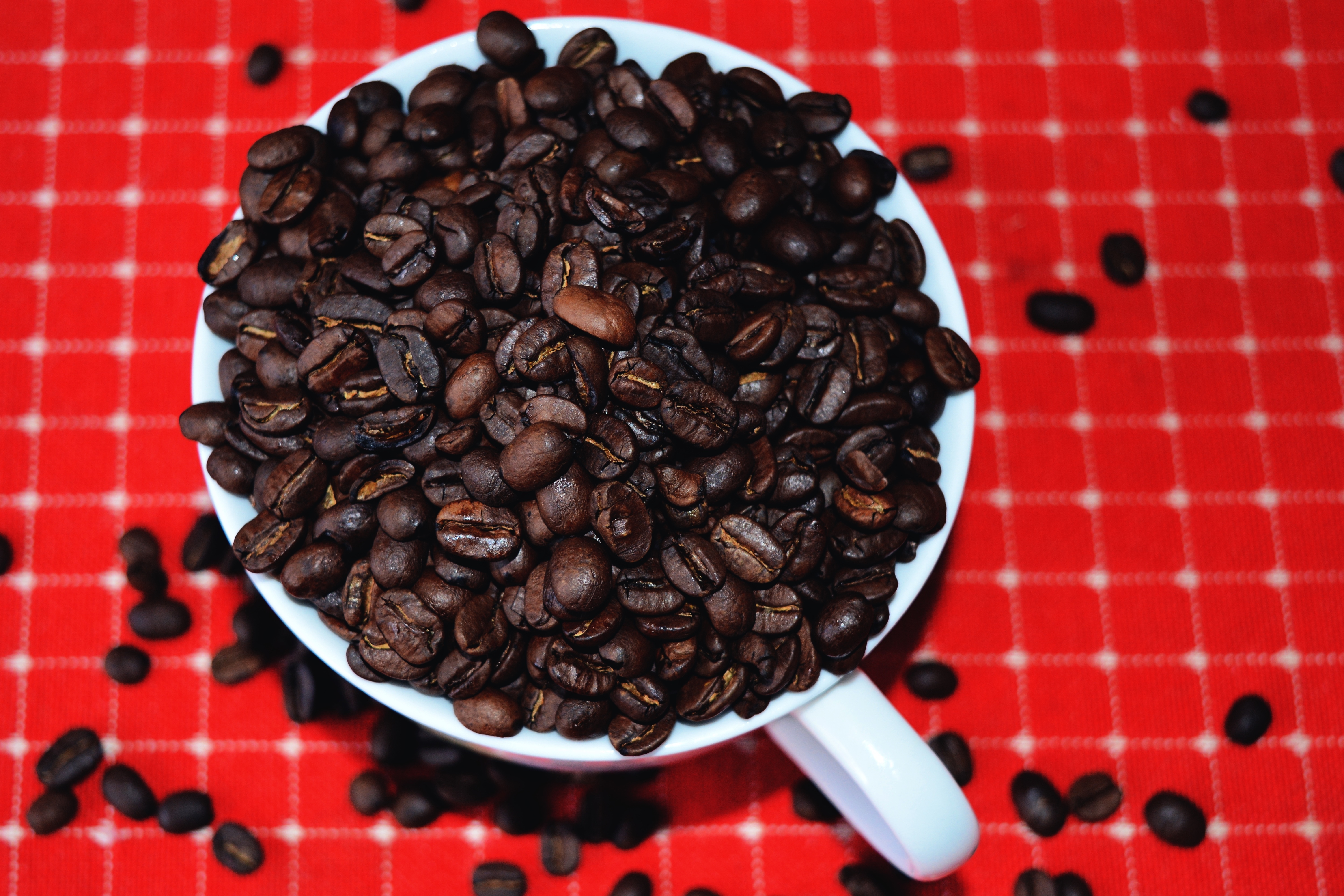 black coffee beans and white ceramic mug