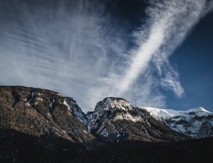 photo of snowy top mountain over viewing blue sky thumbnail