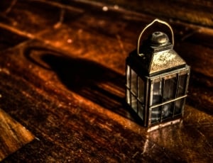 brass candle lantern on wooden platform thumbnail