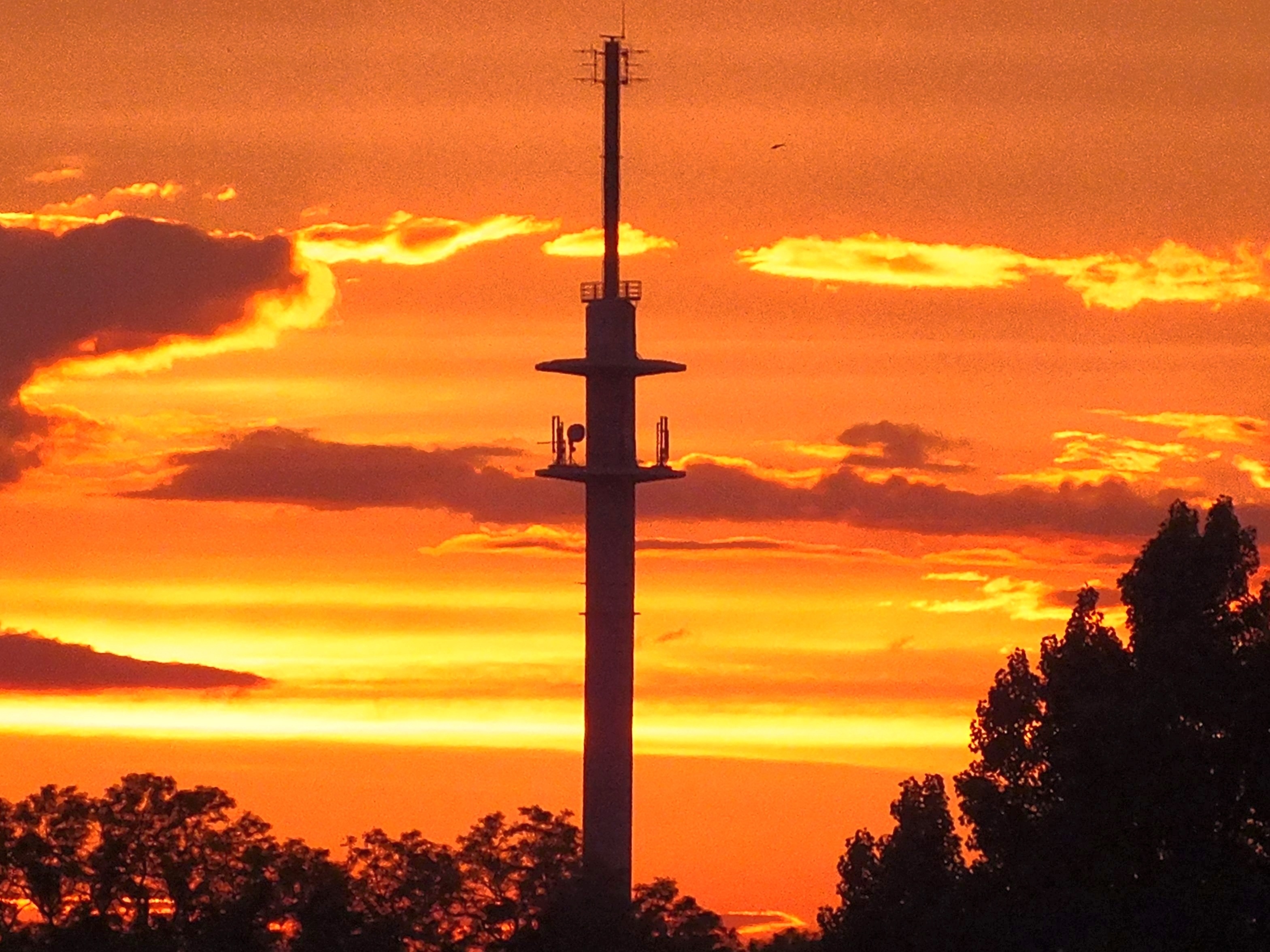 signal tower during sunset