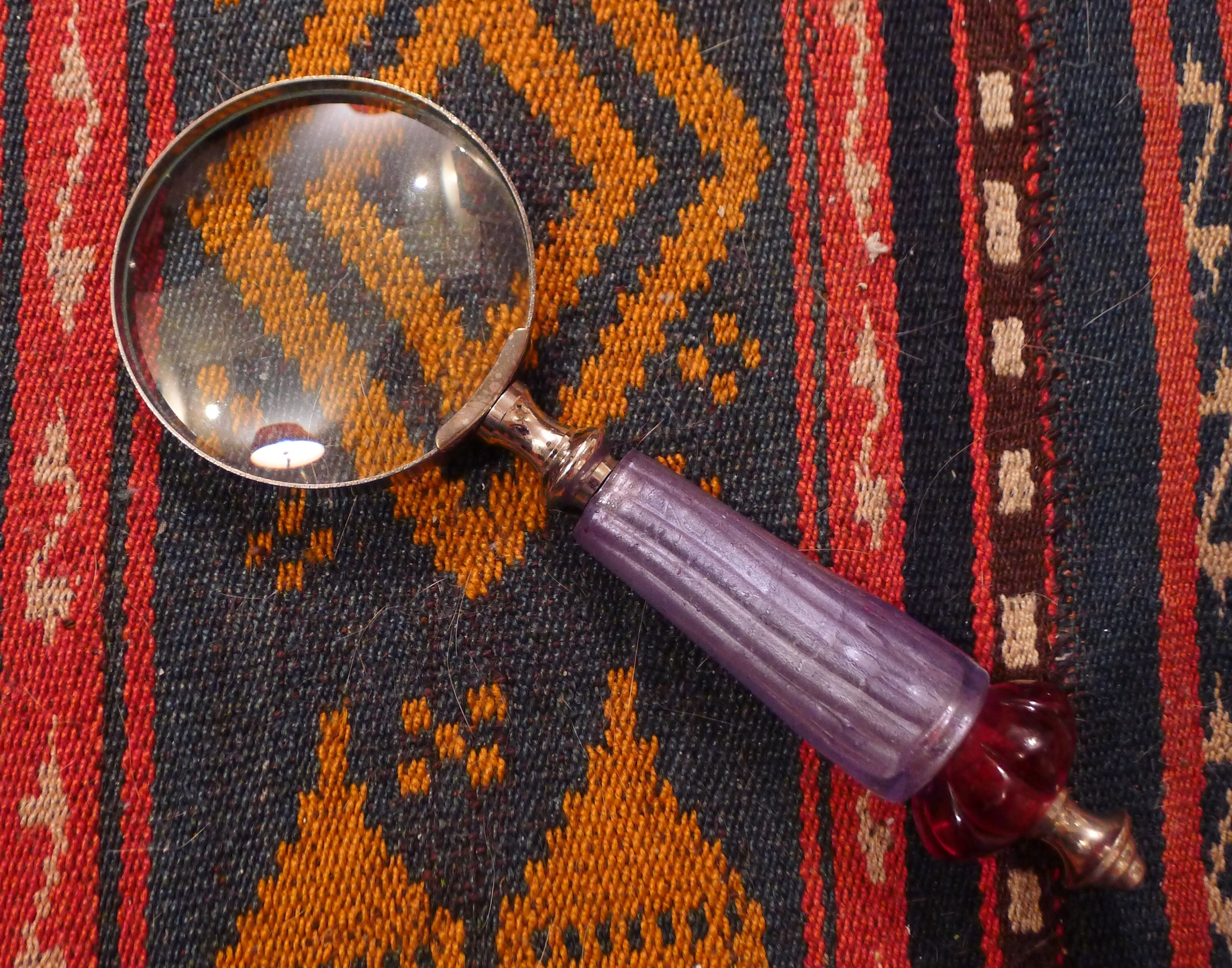 purple and silver magnifying glass