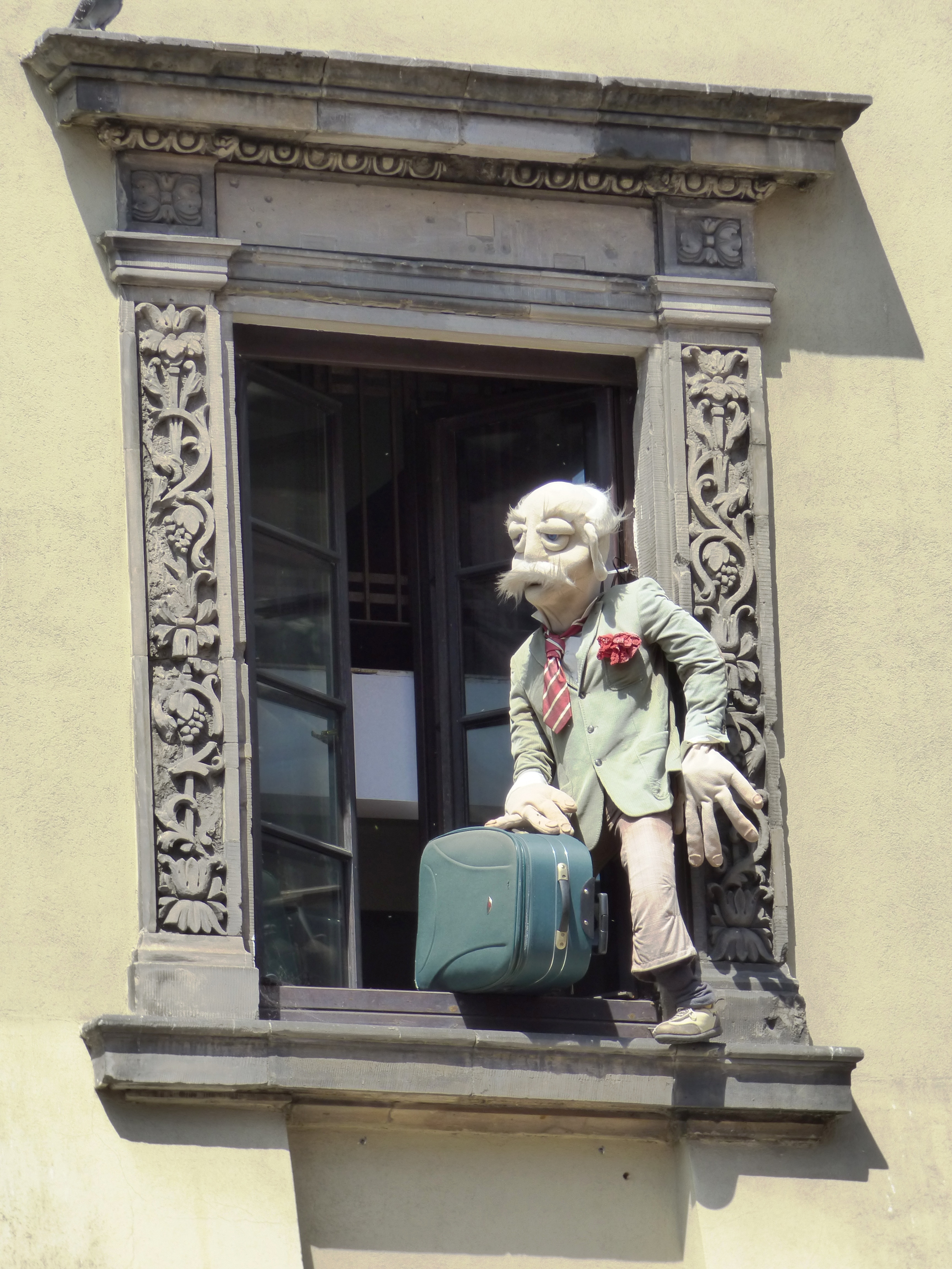 man holding luggage puppet