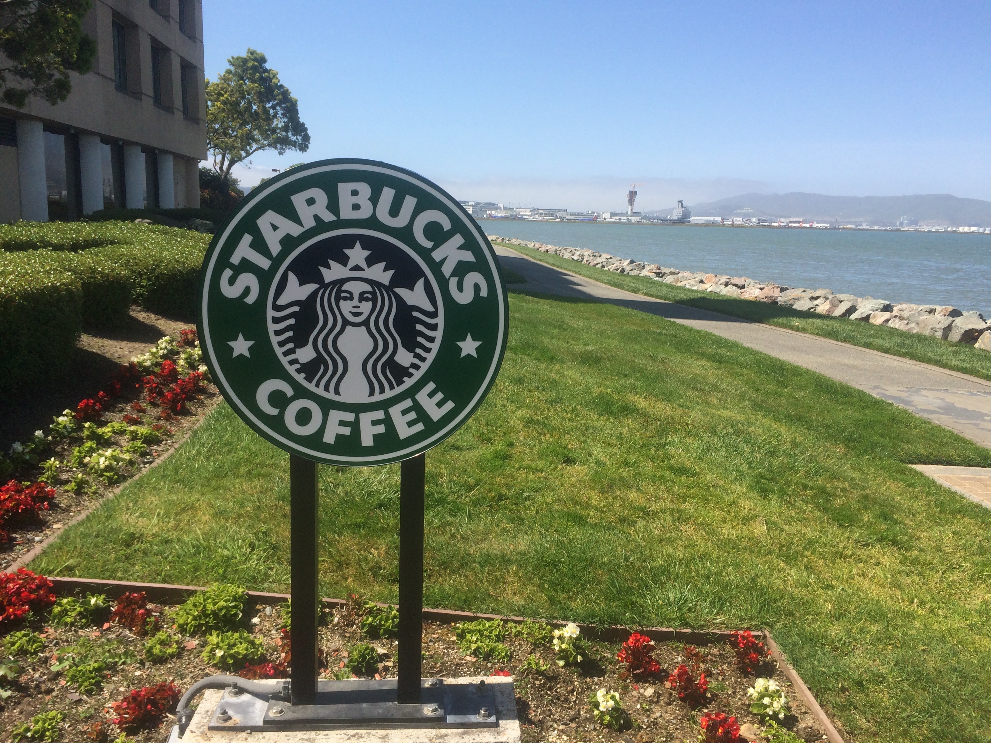 Starbucks Coffee outdoor signage near the ocean