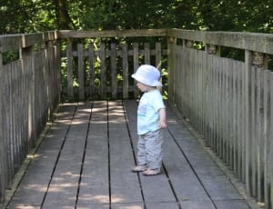 toddler wearing hat walking outside thumbnail