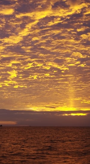 photo of clouds illuminated at golden hour thumbnail