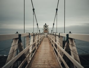 close photo of white wooden bridge near body of water thumbnail