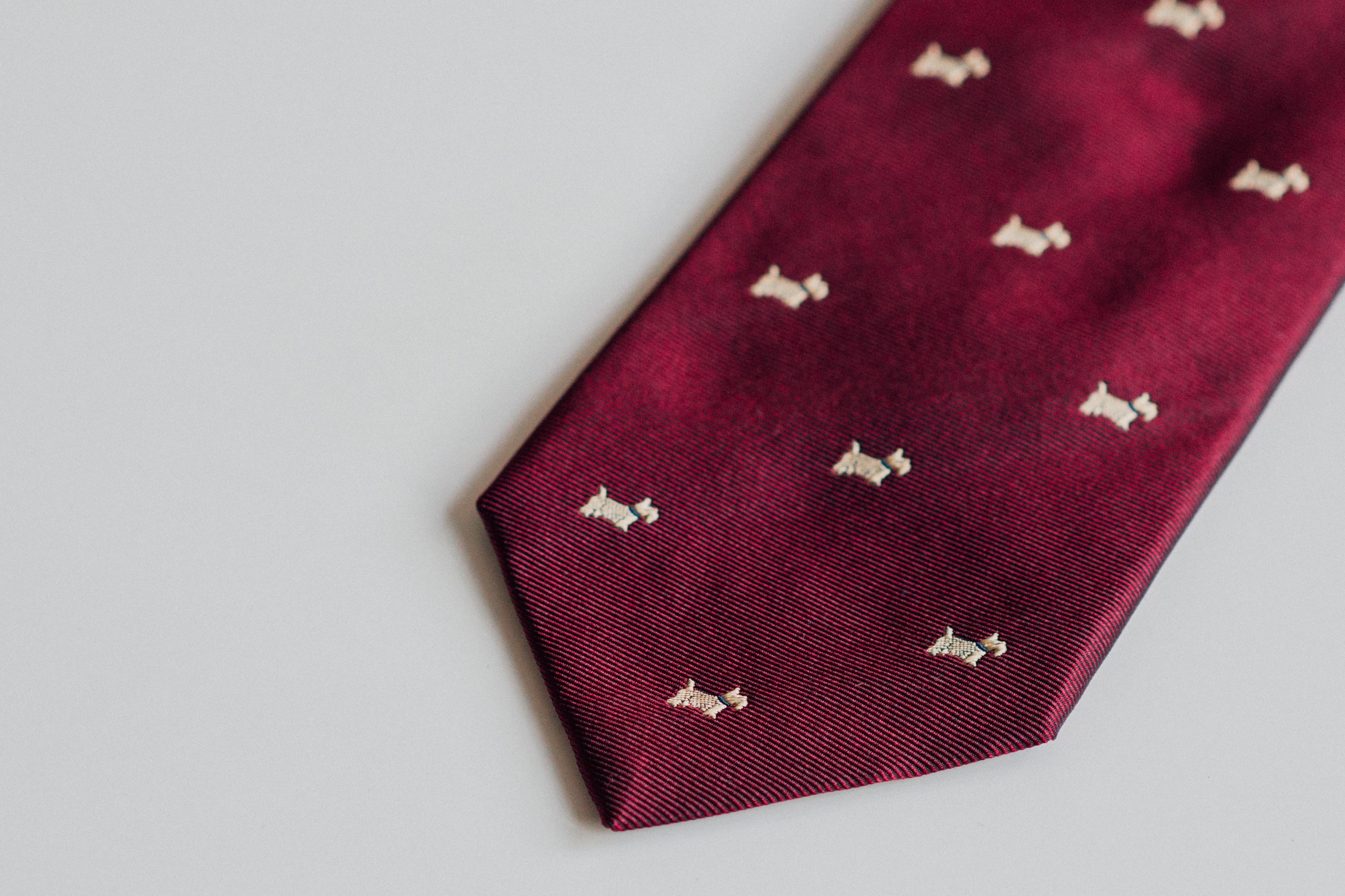close up photo of maroon and white necktie
