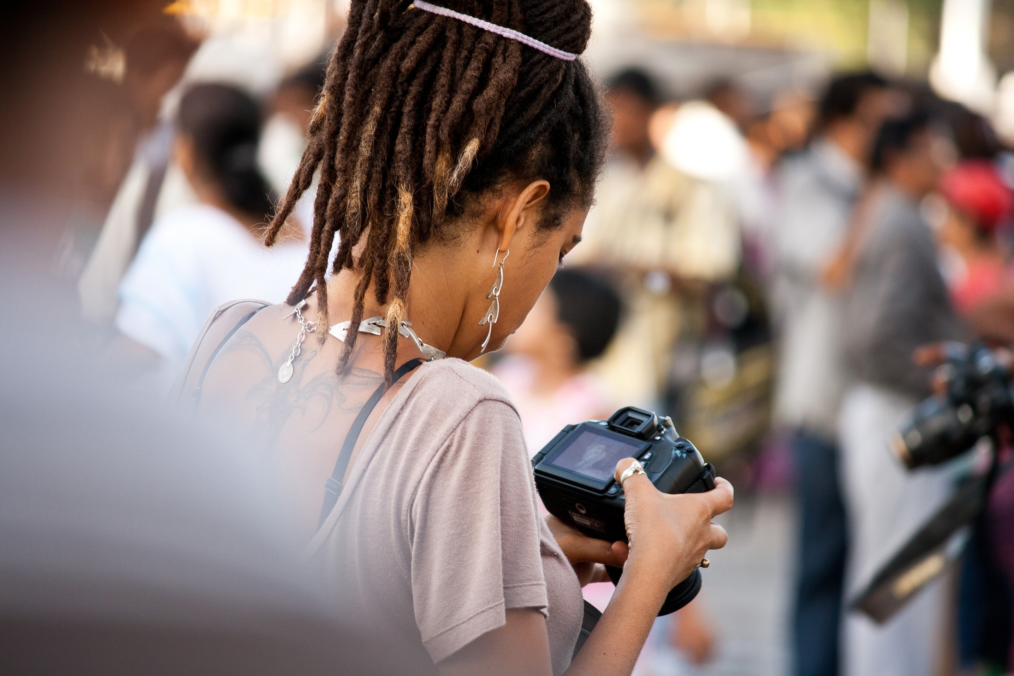 woman holding dslr camera during daytime