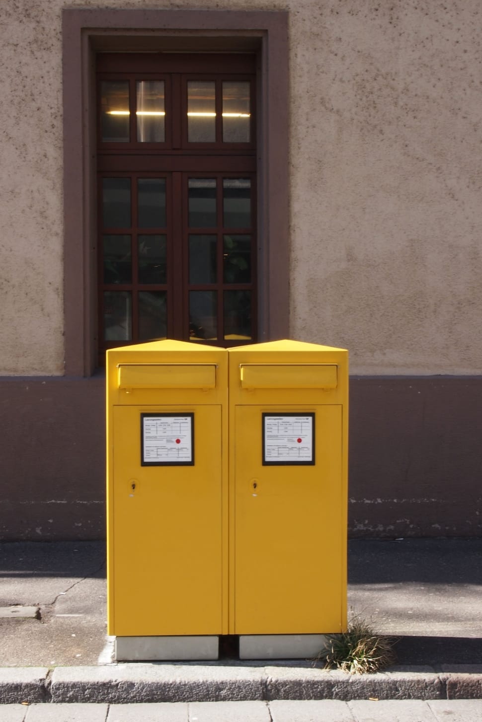 yellow trash bins on gray concrete road preview