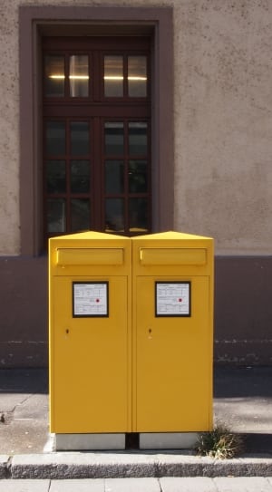 yellow trash bins on gray concrete road thumbnail