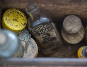 clear glass bottles on brown wooden container thumbnail