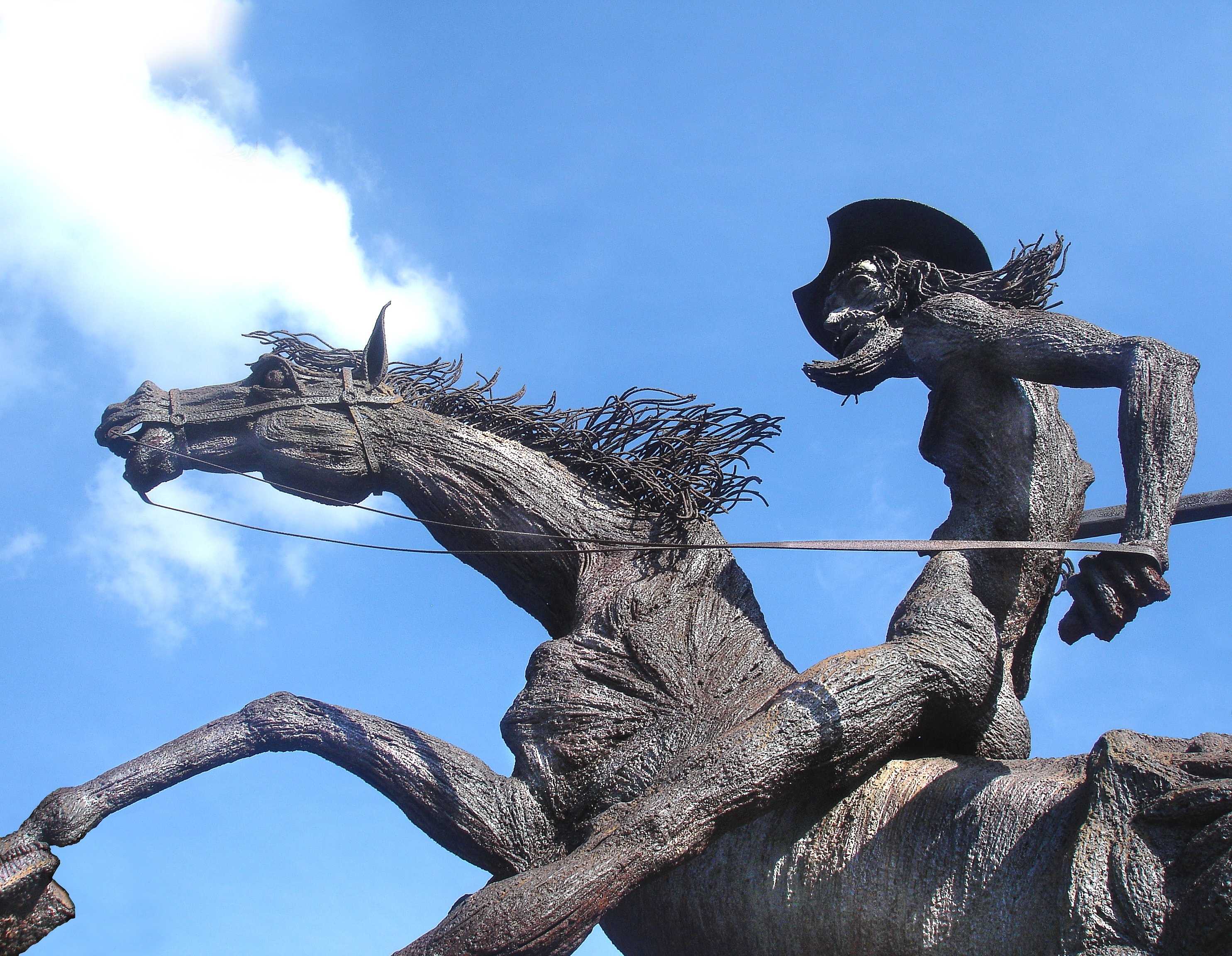 man riding horse black statute