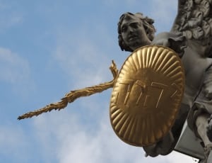 gray angel with brass shield and sword statue thumbnail