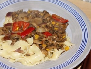pasta with saute mushroom on the white ceramic plate thumbnail