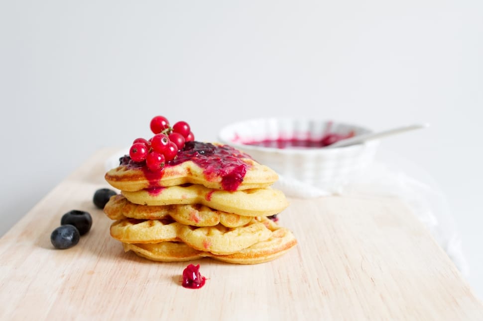 waffle with black and red berries topping and red jam preview