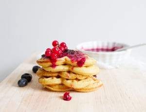 waffle with black and red berries topping and red jam thumbnail