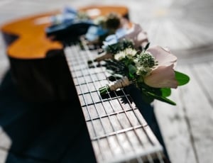 black and brown guitar on table thumbnail
