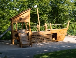 brown wooden ship playset beside trees thumbnail