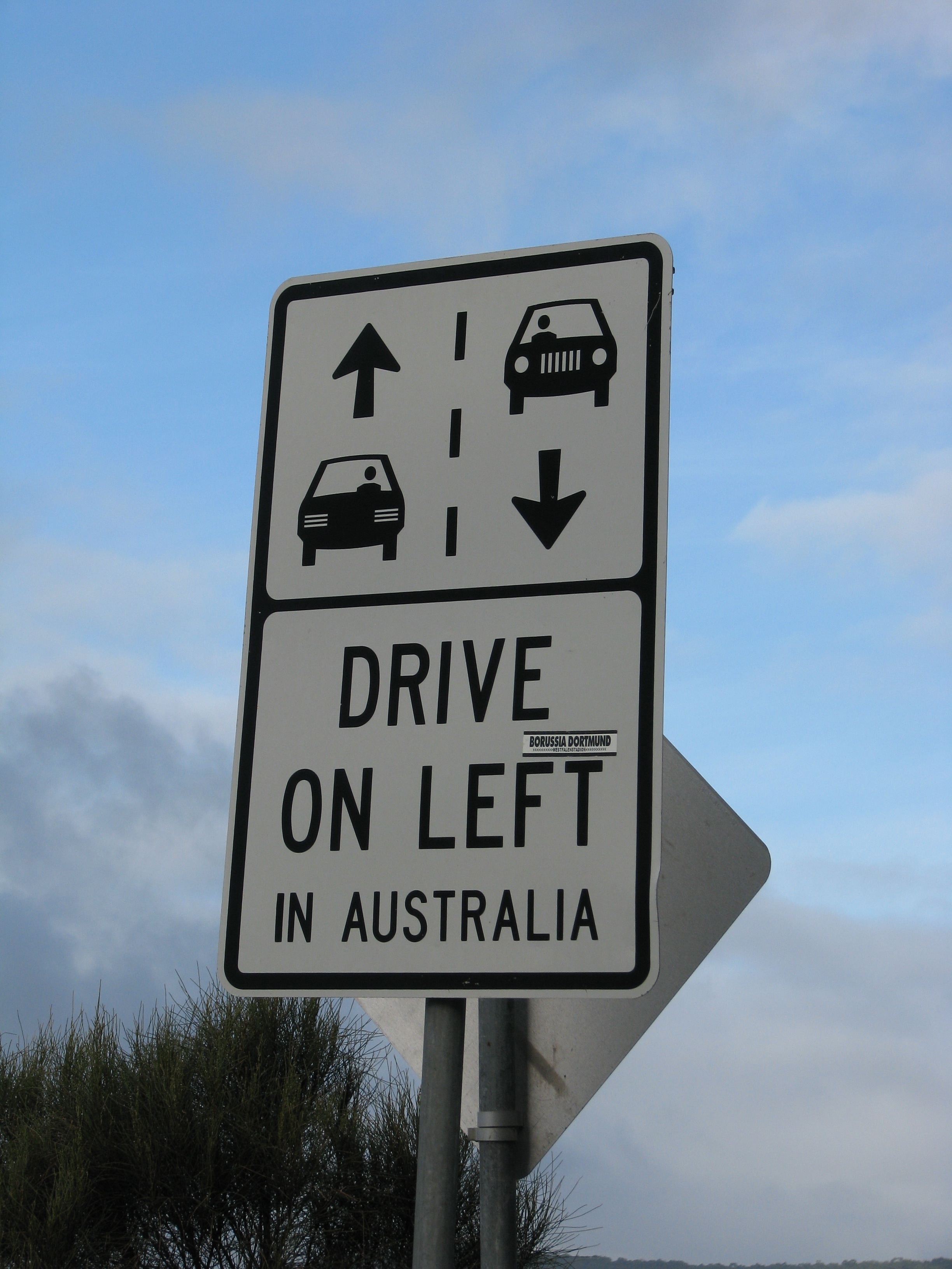 white and black drive on left in australia signage