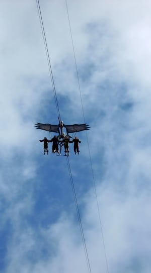 4 person riding zipline during during daytime thumbnail
