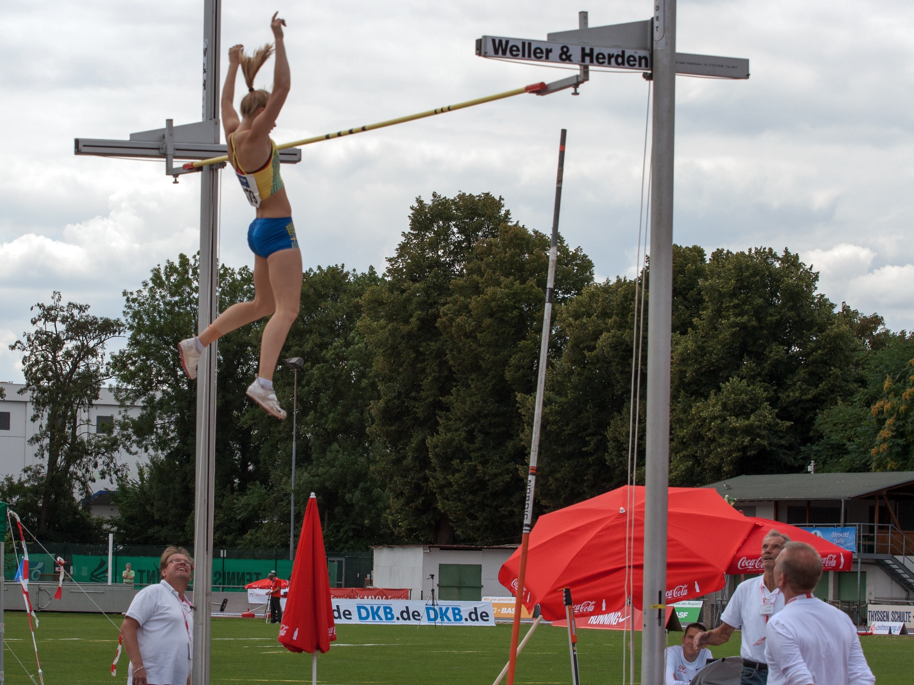 woman playing pole vault during daytime