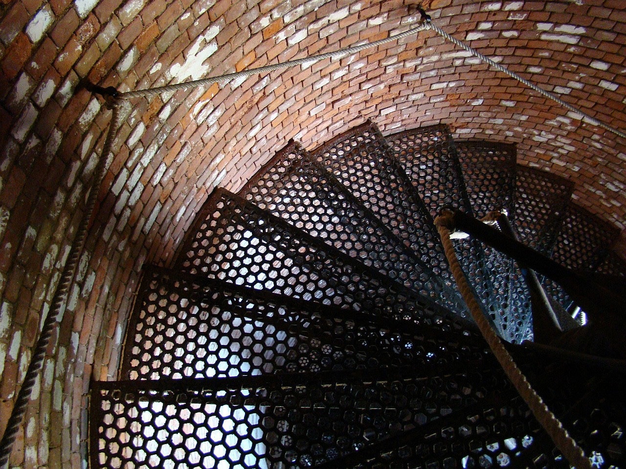 black metal spiral stair in brown wooden tower