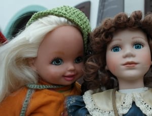 2 dolls wearing green knit cap and white lace peter pan collar thumbnail