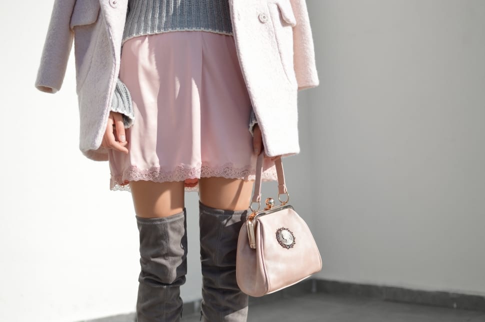 person wearing a pink mini skirt while holding a pink handbag preview