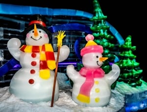two snowman wearing scarves figurines thumbnail