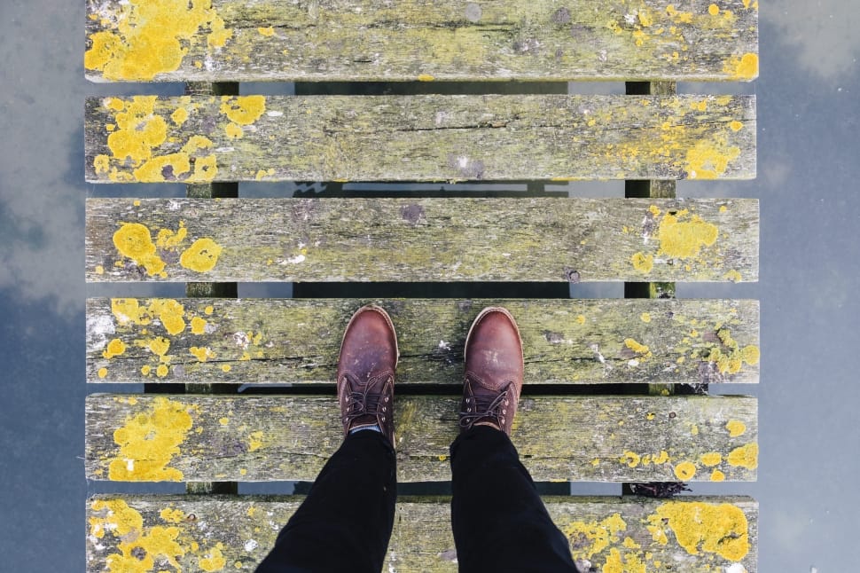 person standing on beige and yellow wooden pallet preview
