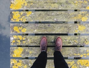 person standing on beige and yellow wooden pallet thumbnail
